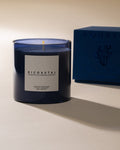 Bicoastal candle in blue glass with its printed box