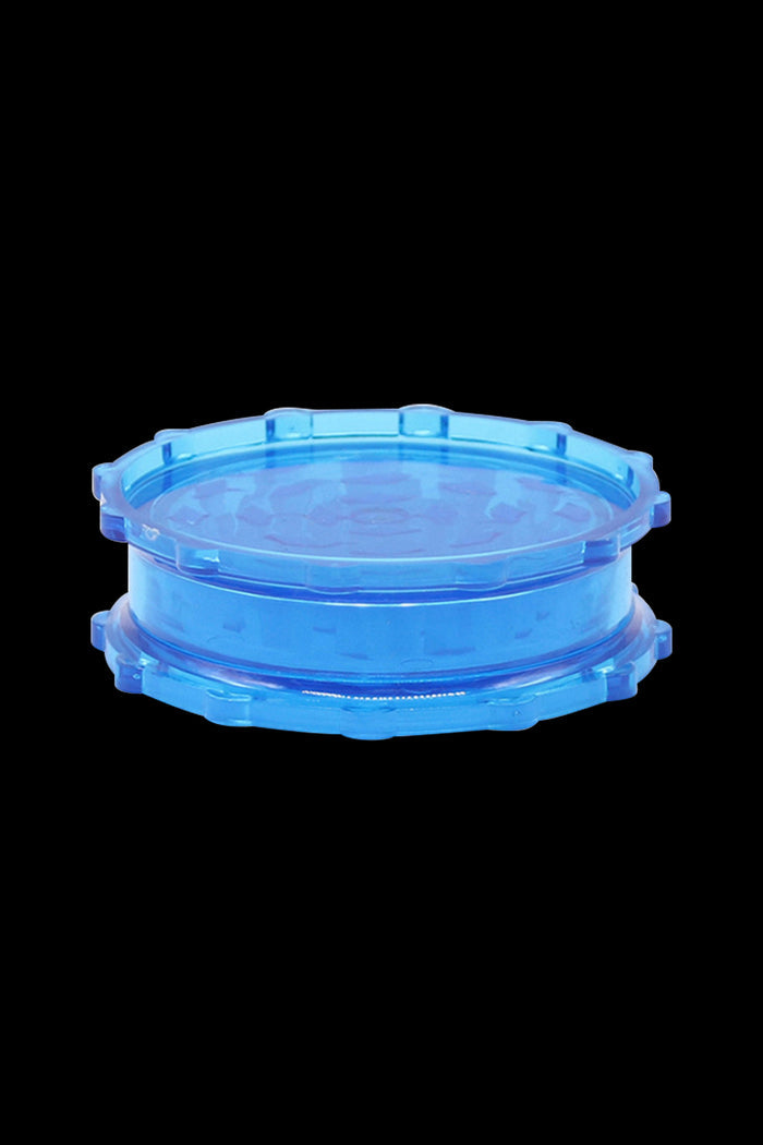 Blue cannabis grinder isolated on a black background.