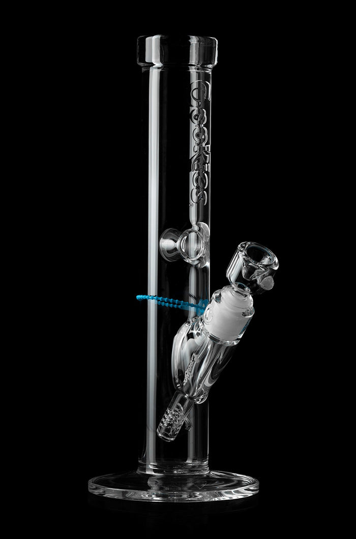 Clear glass water pipe (bong) with intricate percolator design, isolated on black.