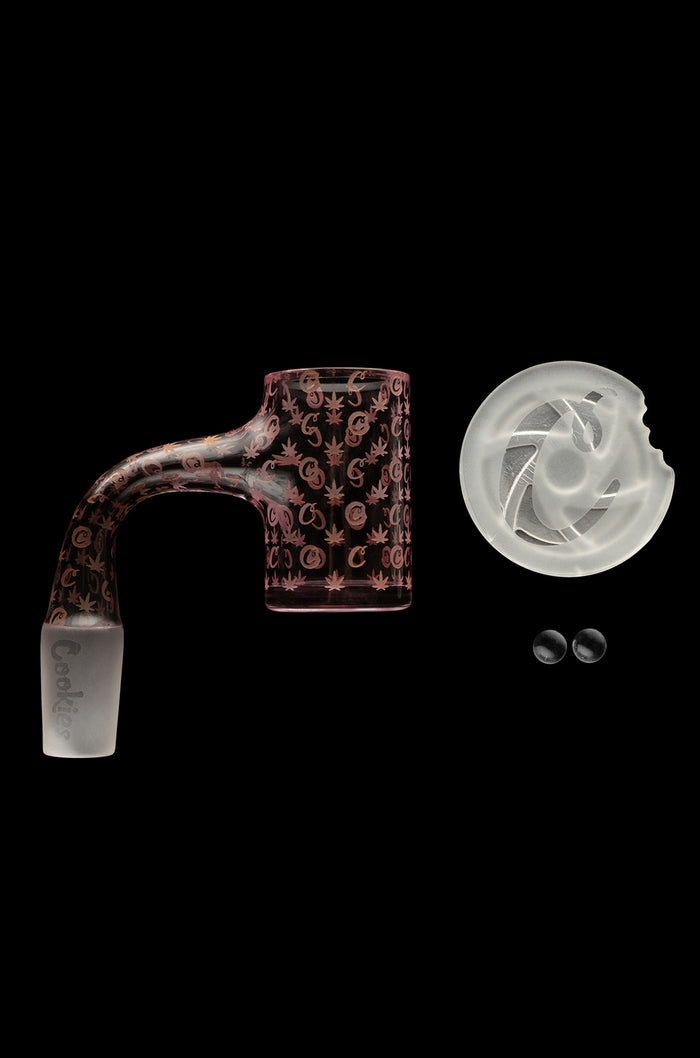 Red cannabis oil rig attachment with marijuana leaf pattern, a quartz insert, and two small silicone caps on a black background.