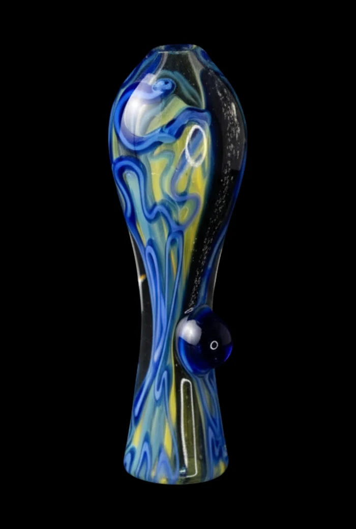 Centered front view of the Brain Fold Chillum Pipe showing blue and yellow swirling glass patterns and a single raised carb bump against a black background