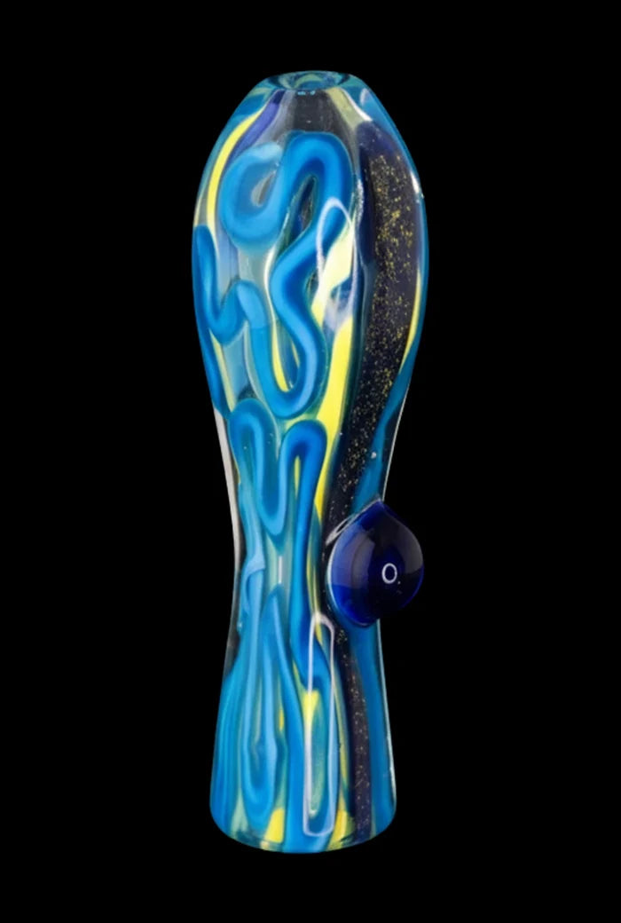 Vertical close-up of a blue-and-yellow Brain Fold Chillum Pipe with swirling glass patterns and a rounded side carb against a black background