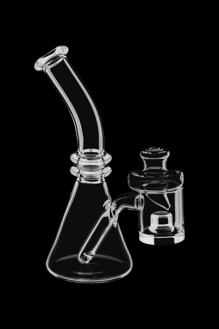 Clear glass bubbler and carb cap set against a black background.