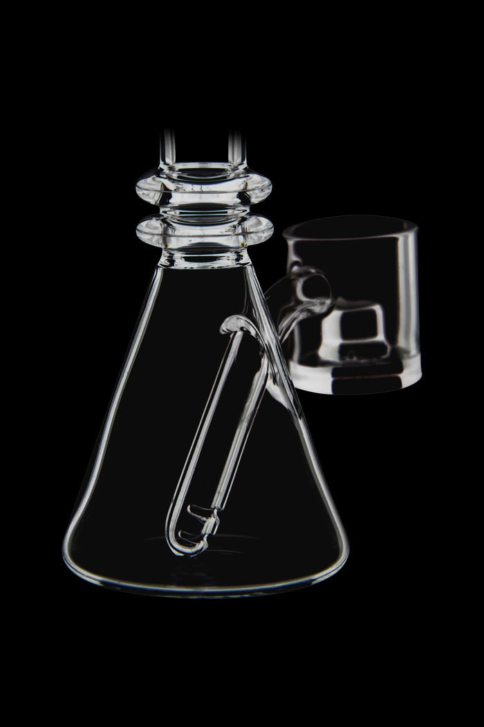 Clear glass bubbler and attachment against a black background.