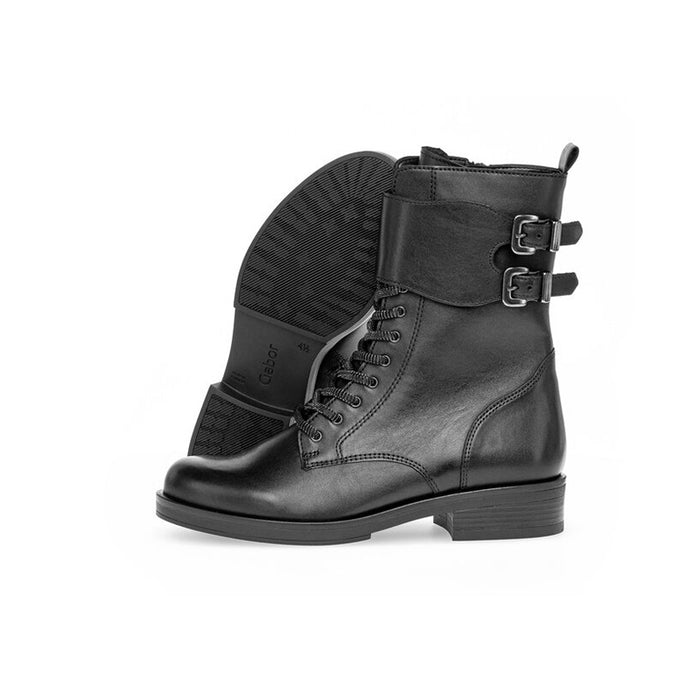 Black leather lace-up boot with side buckles and textured sole