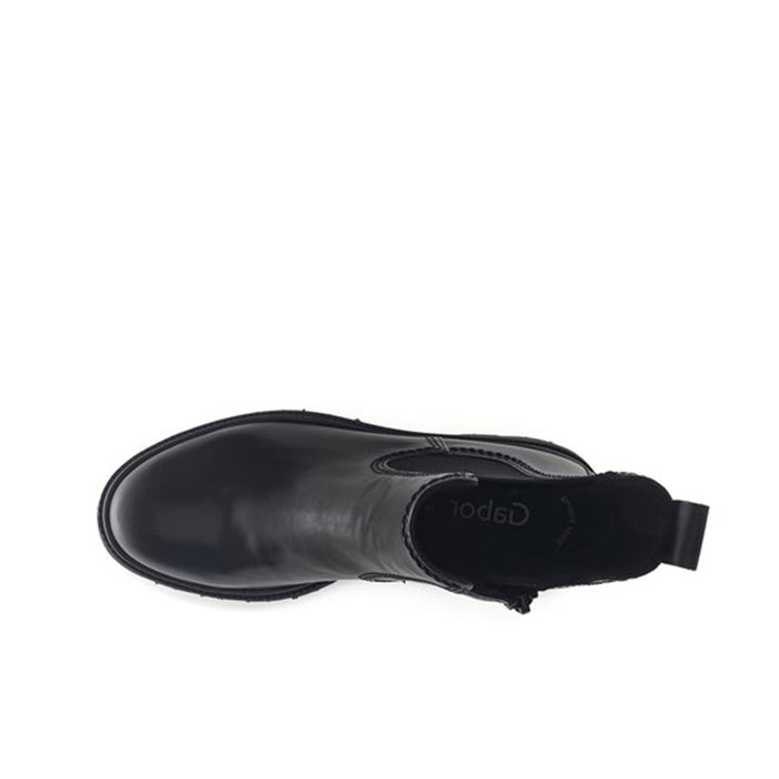 Black leather Chelsea boots with strap detail and dark rubber sole, side view
