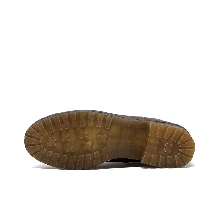 Brown boot outsole with textured traction pattern and rugged tread
