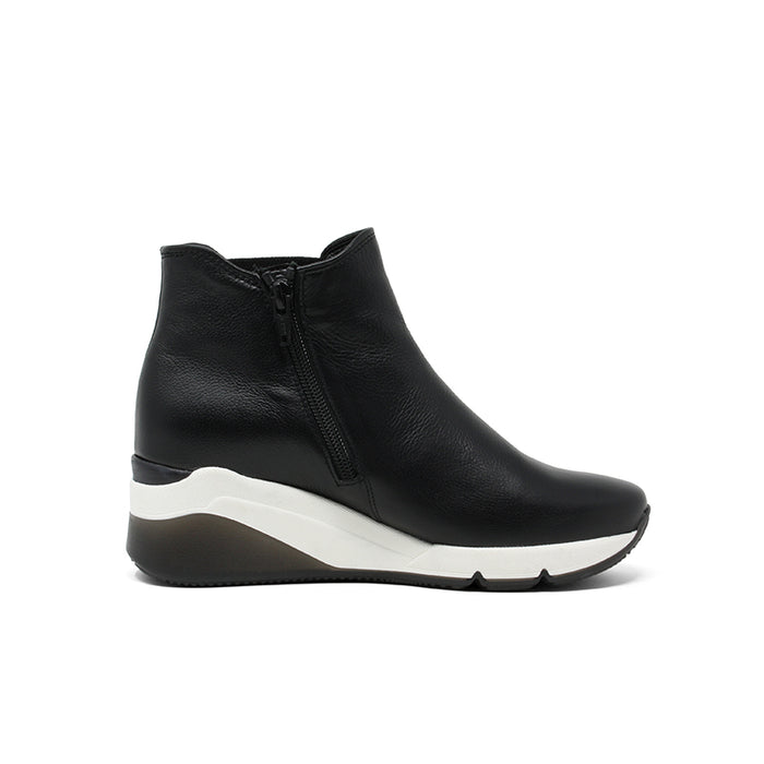 Black leather ankle boot with side zip and white sole wedge