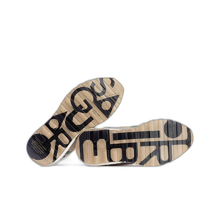 Men's sneaker soles with bold black lettering and tread pattern