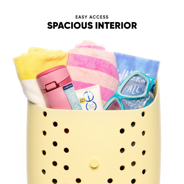 Cream-colored storage backpack with perforated design containing beach essentials: striped towels, pink water bottle, sunscreen, and turquoise swim mask. Text reads "Easy Access" and "Spacious Interior."