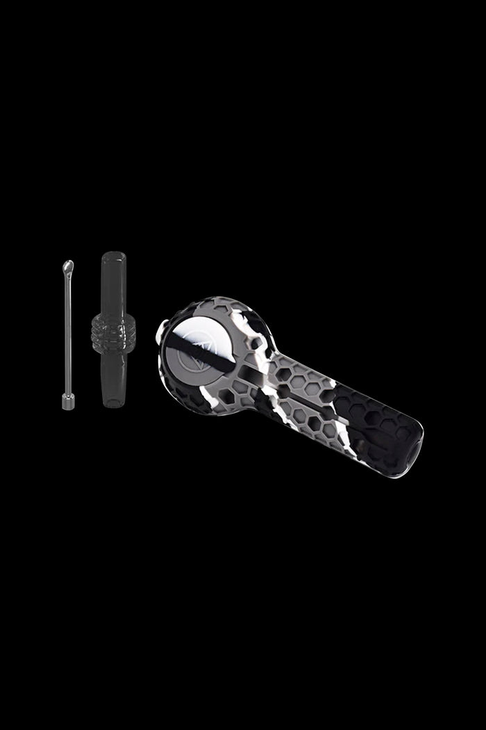 Black and white glass dab rig with tools against a black background.