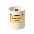 Saint Jane Sacred Candle in a white ceramic vessel with an engraved gold plate