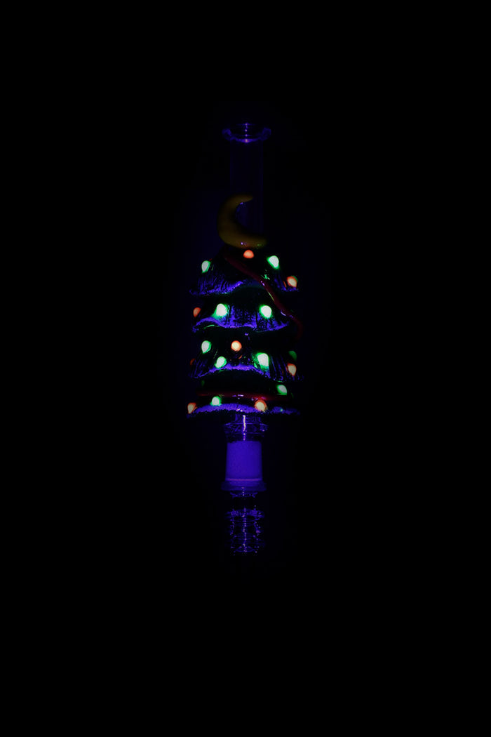 Glowing glass bong with colorful bubbles against a dark background.