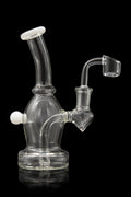 Clear glass dab rig with a quartz banger, studio shot on a black reflective surface.