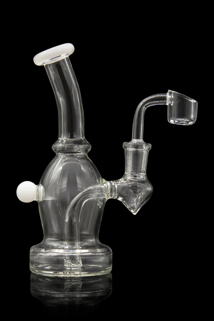 Clear glass dab rig with a quartz banger, studio shot on a black reflective surface.