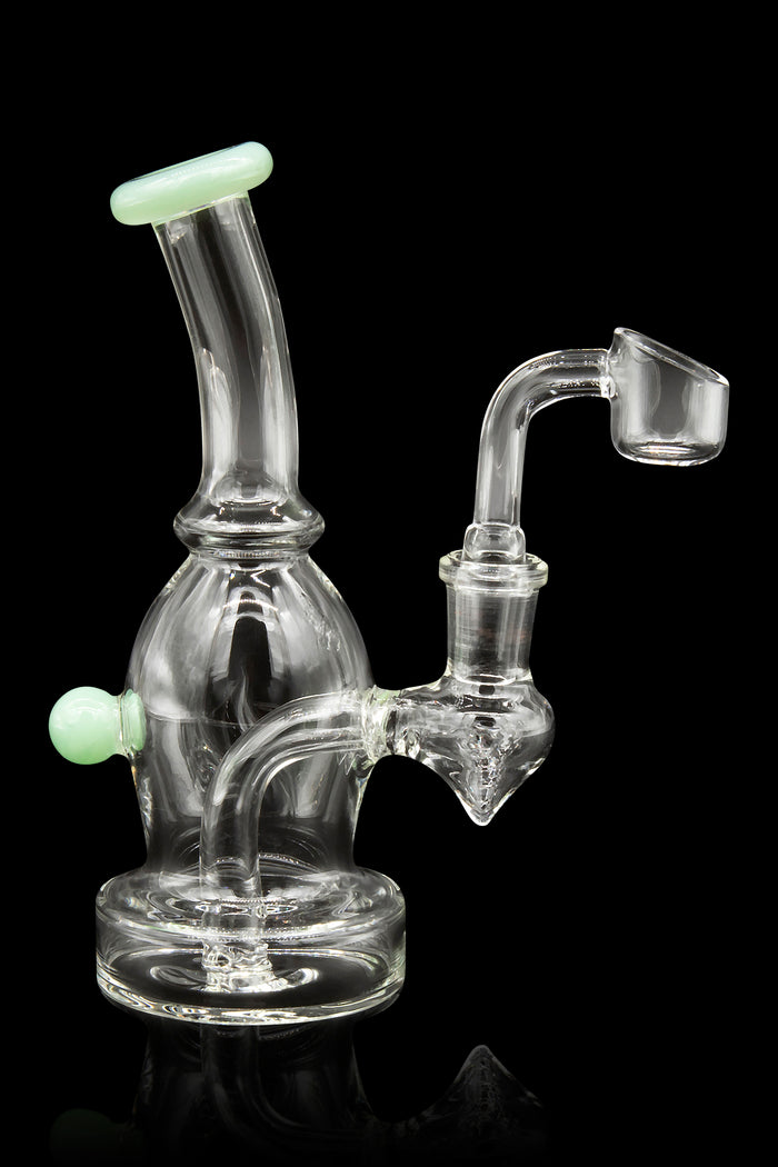 Clear glass bubbler rig with a quartz banger, isolated on a black background.