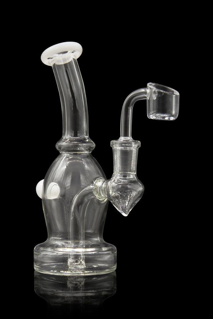 Clear glass dab rig with a quartz banger, isolated on a black background.