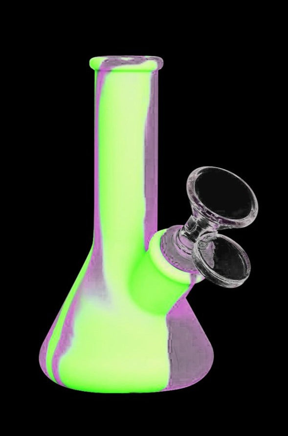 Front-facing view of the Silicone Beaker Travel Bong - Lil' Doink in neon green with purple accents against a black background.